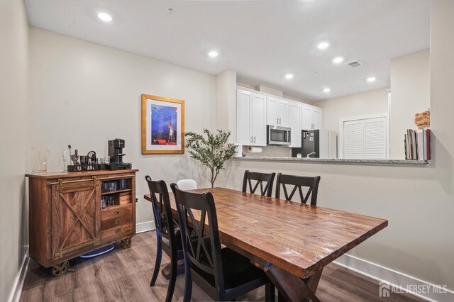 dining area featuring hardwood / wood-style flooring