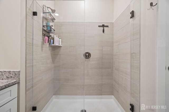 bathroom featuring vanity and an enclosed shower