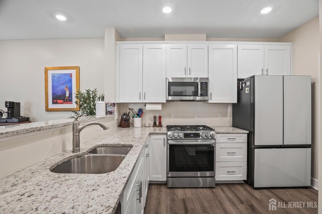 kitchen featuring sink, white cabinets, and appliances with stainless steel finishes