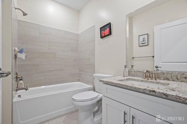 full bathroom with tiled shower / bath combo, vanity, tile patterned floors, and toilet