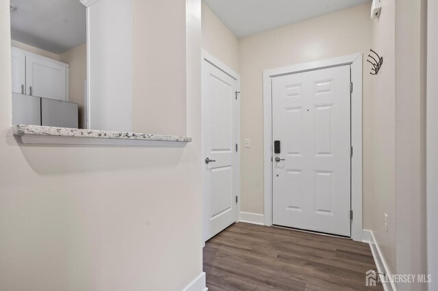 doorway with dark hardwood / wood-style floors