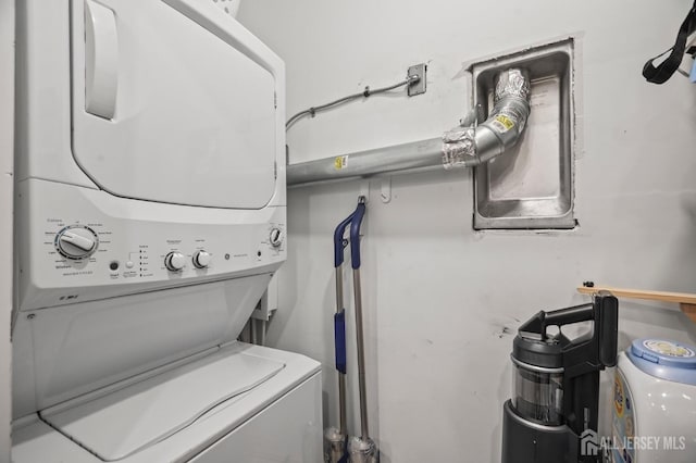 clothes washing area with stacked washer and dryer