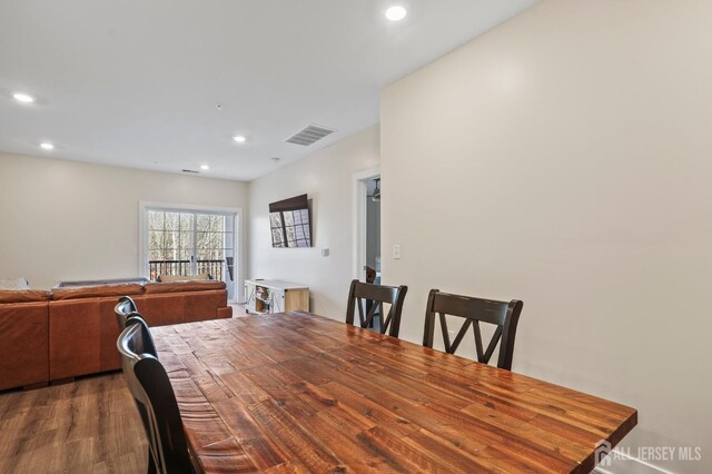 dining space with dark wood-type flooring