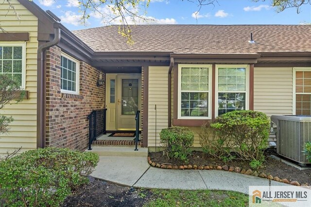 property entrance featuring central AC unit