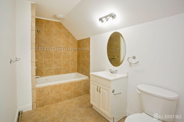 full bathroom featuring vanity, tile patterned flooring, vaulted ceiling, toilet, and tiled shower / bath