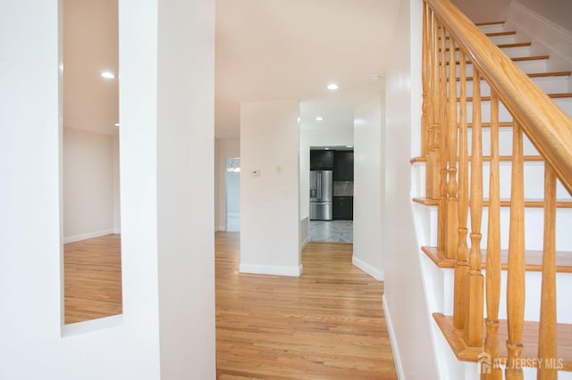 hall with stairway, recessed lighting, baseboards, and wood finished floors