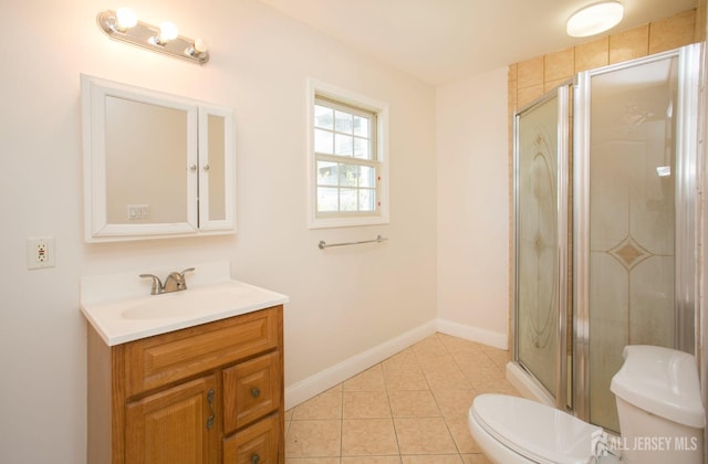 full bathroom featuring tile patterned flooring, baseboards, toilet, a stall shower, and vanity