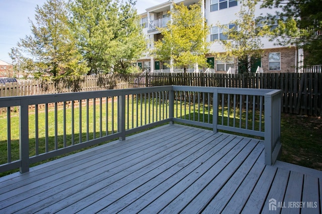 wooden terrace featuring a yard and a fenced backyard