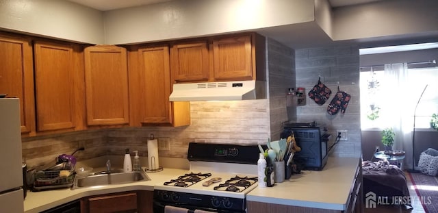 197 Evergreen Rd Unit 3A, Edison, NJ 08837 - kitchen featuring white gas range oven, under cabinet range hood, decorative backsplash, and freestanding refrigerator