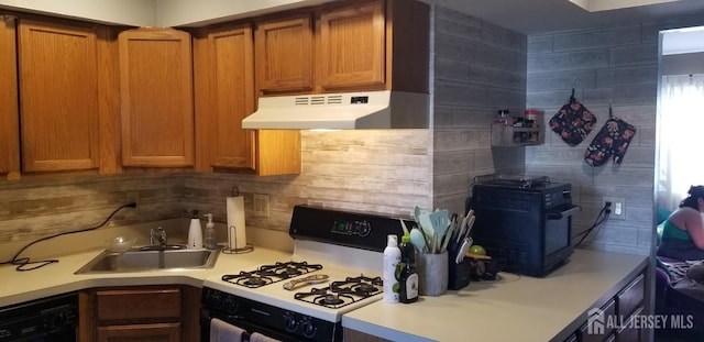 197 Evergreen Rd Unit 3A, Edison, NJ 08837 - kitchen featuring white gas range oven, dishwashing machine, under cabinet range hood, light countertops, and decorative backsplash