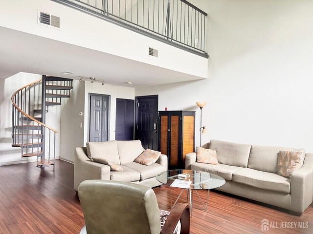 832 Edpas Rd, New Brunswick, NJ 08901 - living area with wood finished floors, stairway, and a towering ceiling