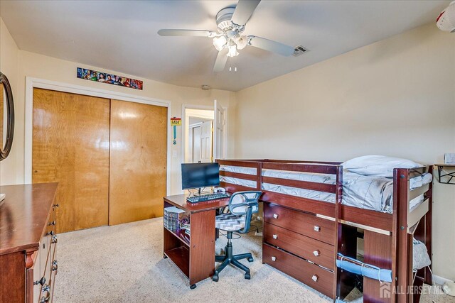 office space with light carpet and ceiling fan