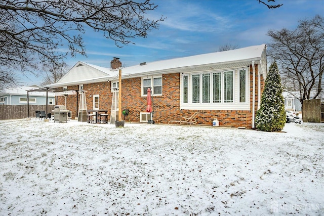 view of snow covered back of property