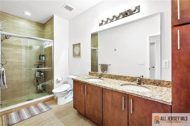 448 Tower Blvd Unit 448, Piscataway, NJ 08854 - bathroom featuring double vanity, toilet, a stall shower, and wood finished floors