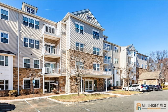 view of property featuring a residential view and uncovered parking