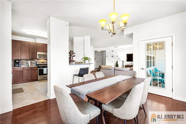 448 Tower Blvd Unit 448, Piscataway, NJ 08854 - dining space with a chandelier, light wood-type flooring, and baseboards