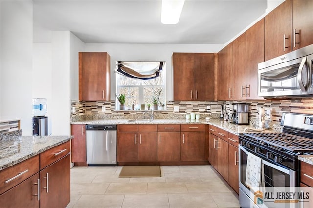 448 Tower Blvd Unit 448, Piscataway, NJ 08854 - kitchen featuring stainless steel appliances, backsplash, light stone counters, light tile patterned floors, and a sink