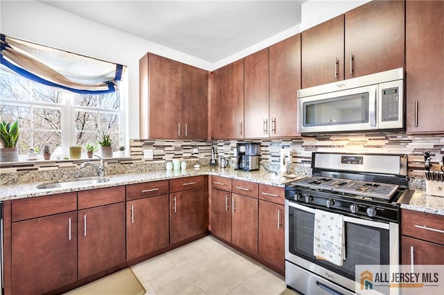 448 Tower Blvd Unit 448, Piscataway, NJ 08854 - kitchen with appliances with stainless steel finishes, a sink, backsplash, light stone counters, and light tile patterned floors