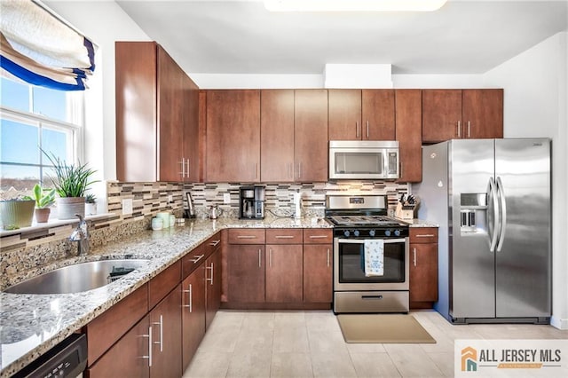 448 Tower Blvd Unit 448, Piscataway, NJ 08854 - kitchen featuring appliances with stainless steel finishes, a sink, backsplash, and light stone counters