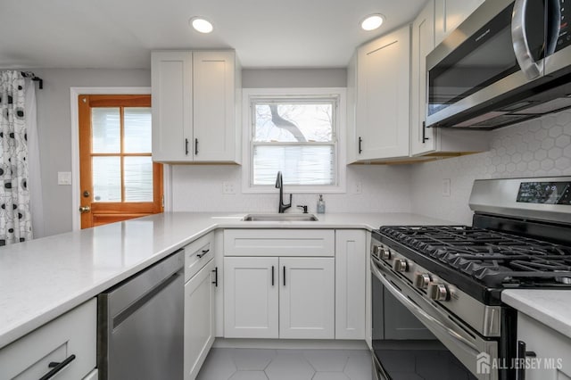 245 Newman St, Metuchen, NJ 08840 - kitchen featuring stainless steel appliances, a sink, light countertops, white cabinets, and recessed lighting