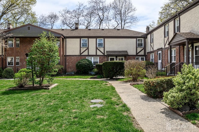 245 Newman St, Metuchen, NJ 08840 - view of front of property featuring a front lawn, stucco siding, a chimney, and brick siding