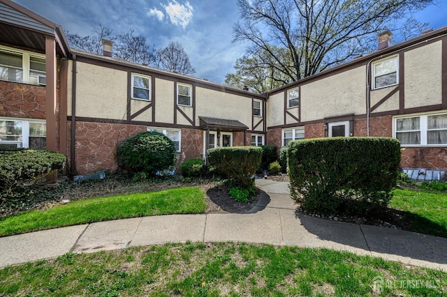 245 Newman St, Metuchen, NJ 08840 - view of front facade with a chimney, stucco siding, and stone siding