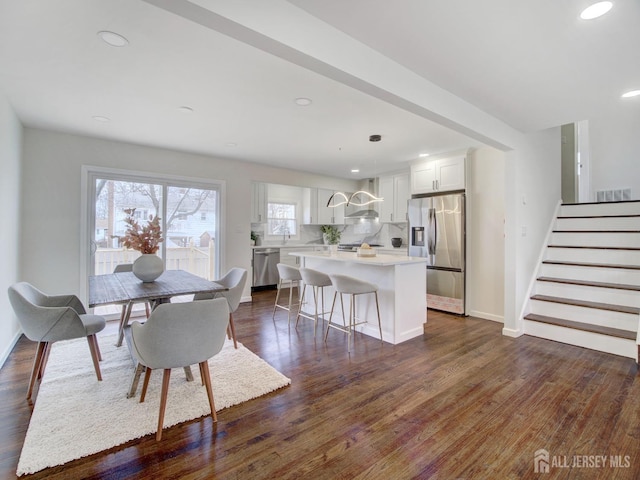 dining area with dark wood-type flooring