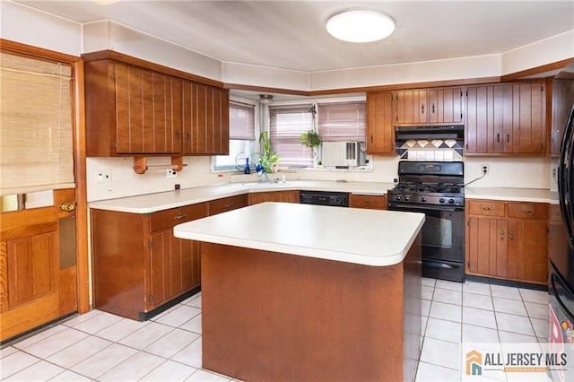 kitchen featuring brown cabinets, light countertops, a sink, black appliances, and exhaust hood