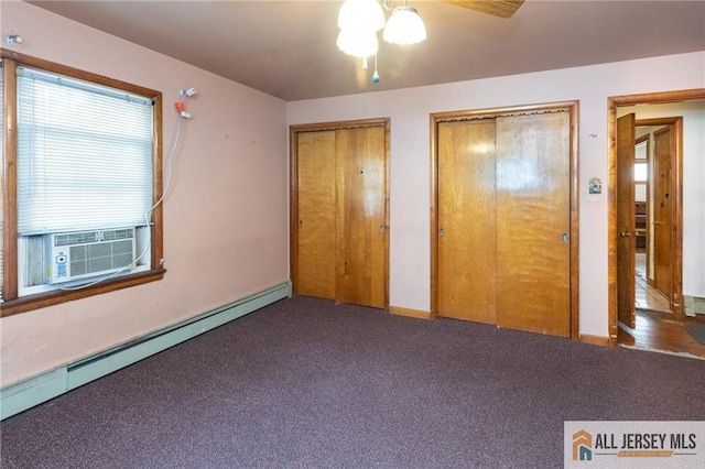 unfurnished bedroom with carpet floors, multiple closets, a baseboard radiator, cooling unit, and baseboards