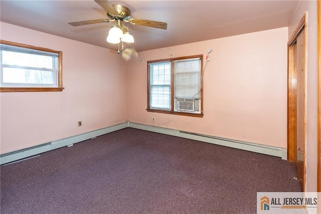 empty room with dark carpet and a ceiling fan