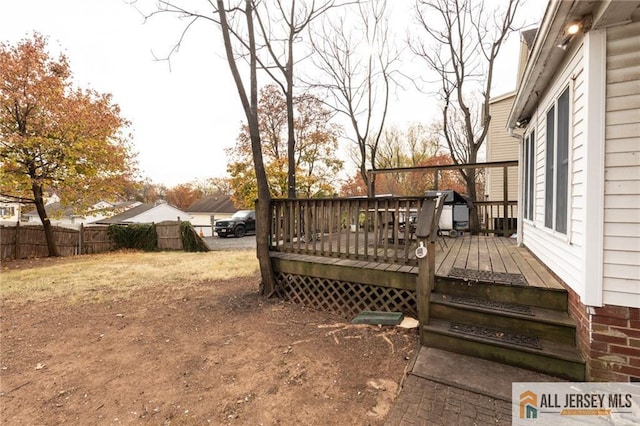 deck with a grill and fence