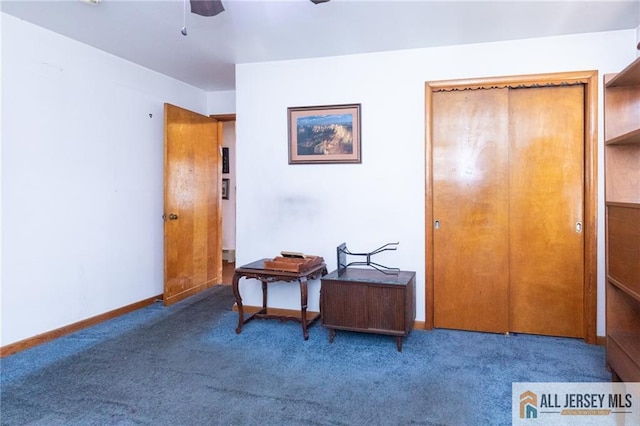 interior space featuring ceiling fan, carpet, and baseboards