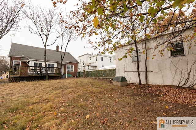 view of yard with a deck and fence