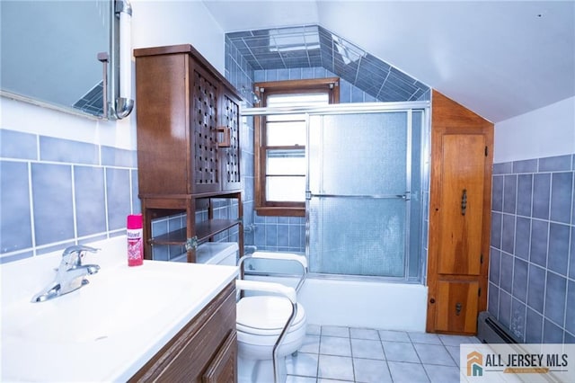 full bathroom featuring lofted ceiling, tile patterned flooring, combined bath / shower with glass door, vanity, and tile walls