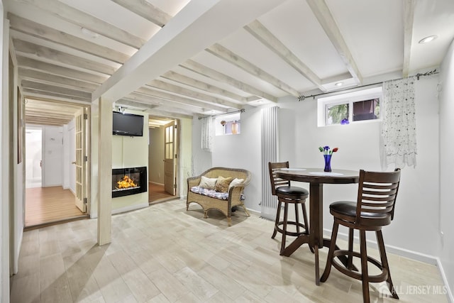 365 E John St, South Amboy, NJ 08879 - dining area featuring a glass covered fireplace, beam ceiling, and baseboards