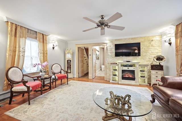 365 E John St, South Amboy, NJ 08879 - living area featuring crown molding, ceiling fan, wood finished floors, a lit fireplace, and stairway