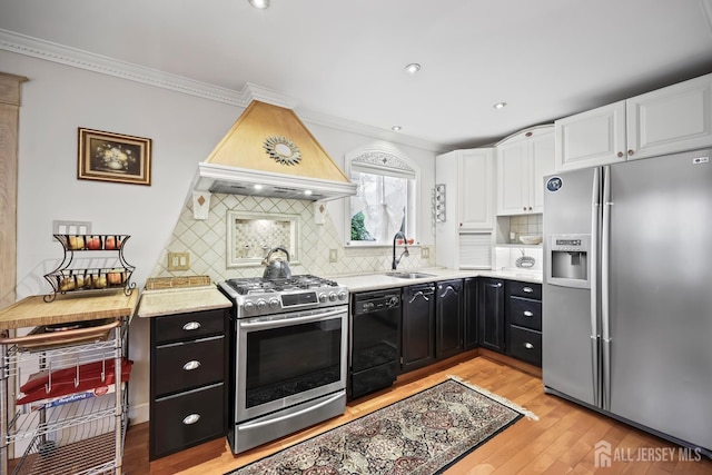 365 E John St, South Amboy, NJ 08879 - kitchen featuring appliances with stainless steel finishes, custom range hood, a sink, dark cabinetry, and white cabinets