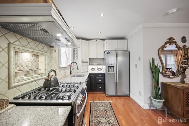 365 E John St, South Amboy, NJ 08879 - kitchen featuring appliances with stainless steel finishes, a sink, premium range hood, backsplash, and white cabinets