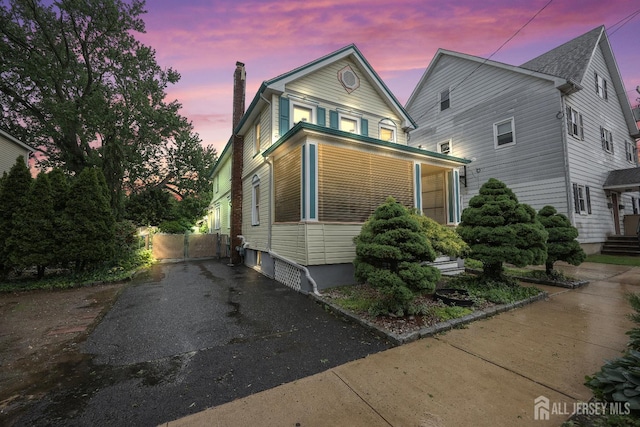 365 E John St, South Amboy, NJ 08879 - traditional home featuring a chimney, a gate, and asphalt driveway