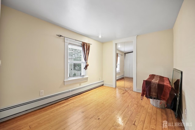 365 E John St, South Amboy, NJ 08879 - spare room featuring baseboard heating, wood-type flooring, a baseboard radiator, and baseboards