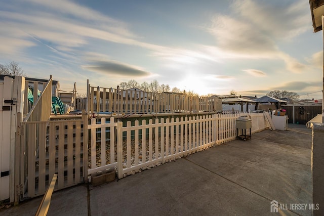 patio terrace at dusk featuring a gazebo