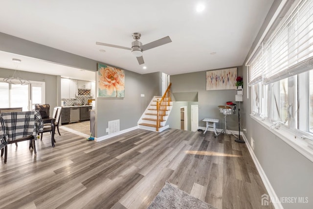 living room with ceiling fan and hardwood / wood-style floors