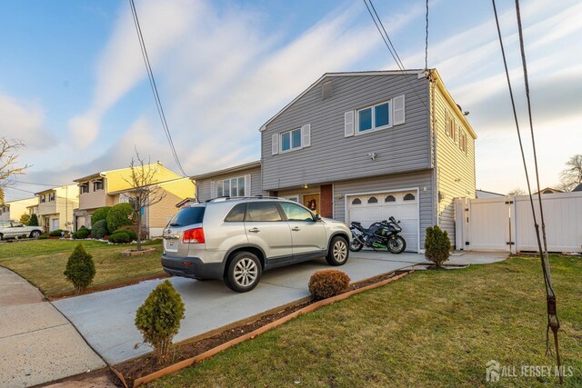 view of front of home featuring a garage and a front lawn