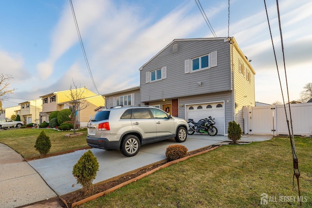 view of front of home with a garage and a front lawn