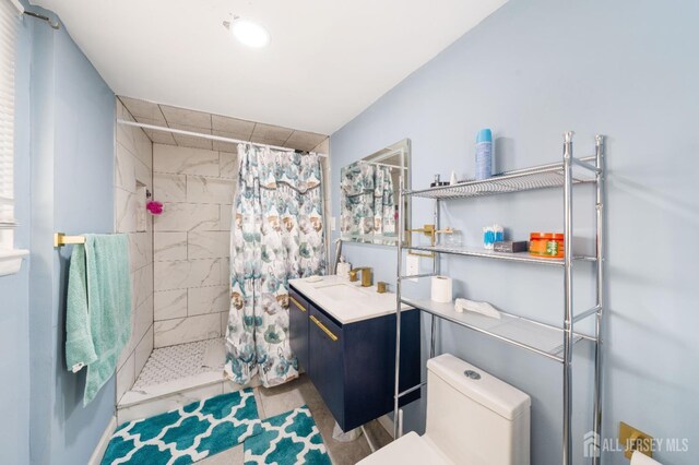 bathroom with vanity, a shower with curtain, and toilet