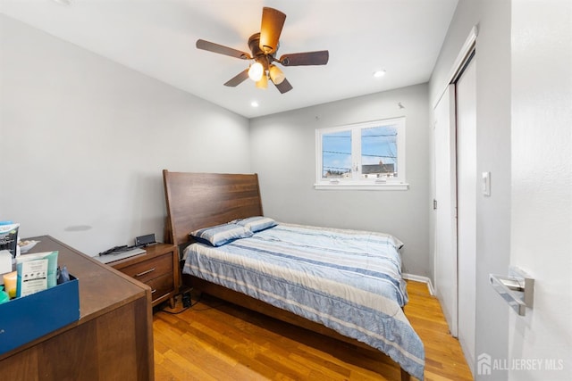 bedroom featuring a closet, ceiling fan, and light wood-type flooring