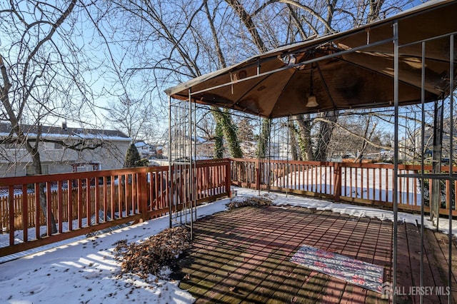 snow covered deck featuring a gazebo