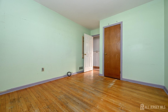 unfurnished bedroom with light hardwood / wood-style floors and a closet