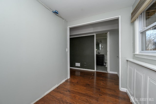 unfurnished bedroom featuring dark hardwood / wood-style flooring