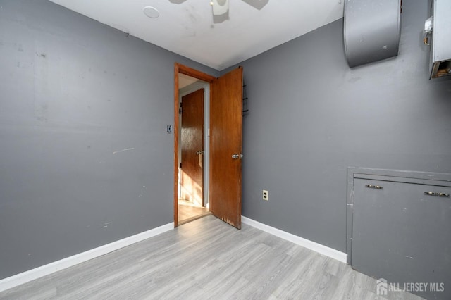 unfurnished room with ceiling fan and light wood-type flooring